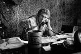 American actor Steve McQueen sitting on his desk in his Hollywood office, making a phone call. 1969.