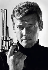British actor Roger Moore poses with a gun as James Bond, late 1970s.