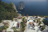 Sunbathers lounge on the white-painted terrace of Il Canille