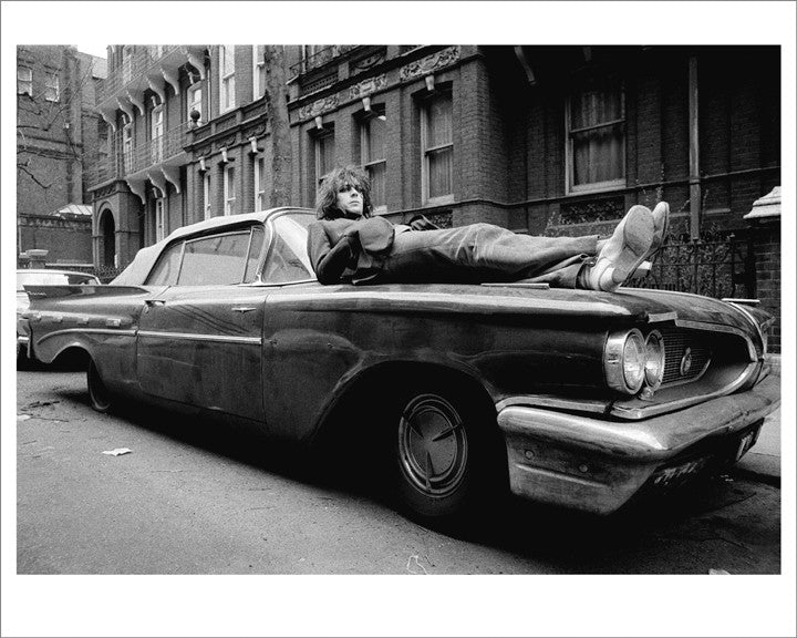 Syd Barrett laying on car.
Mad Cap Laughs album session.
London, UK. 1969