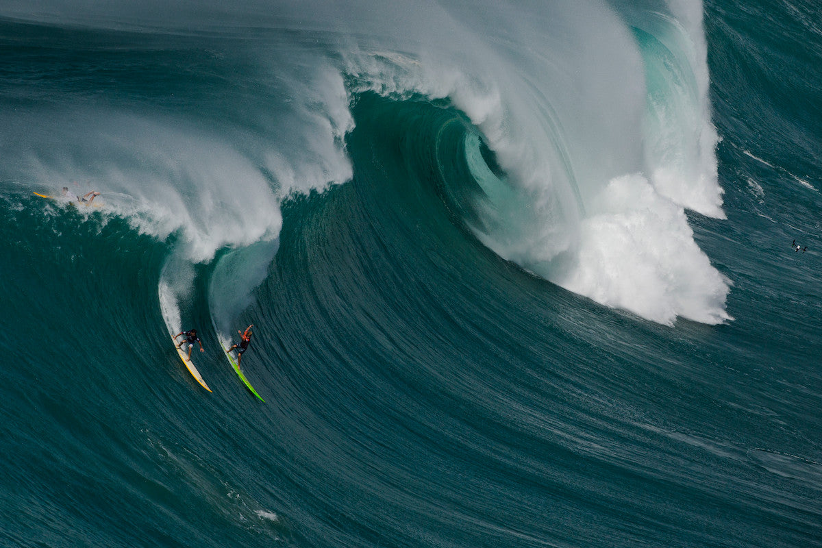 Mason Ho and John John Florence taking a wave at the Eddie Aikau Invitational 2014.