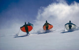 Led by skimaster Stein Eriksen, skiers 'sail' down a slope at Snowmass-at-Aspen, Colorado, circa 1967.