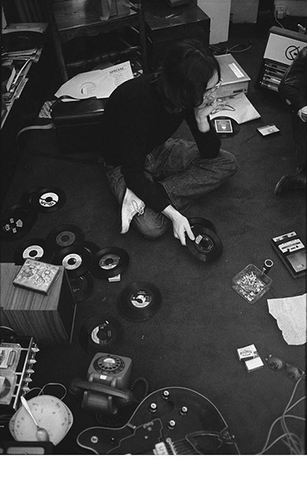 John Lennon, listening to test pressing 45s of The White Album in 1968.