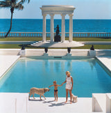 American writer C.Z. Guest (Mrs F.C. Winston Guest, 1920 - 2003) and her son Alexander Michael Douglas Dudley Guest in front of their Grecian temple pool on the ocean-front estate, Villa Artemis, Palm Beach.