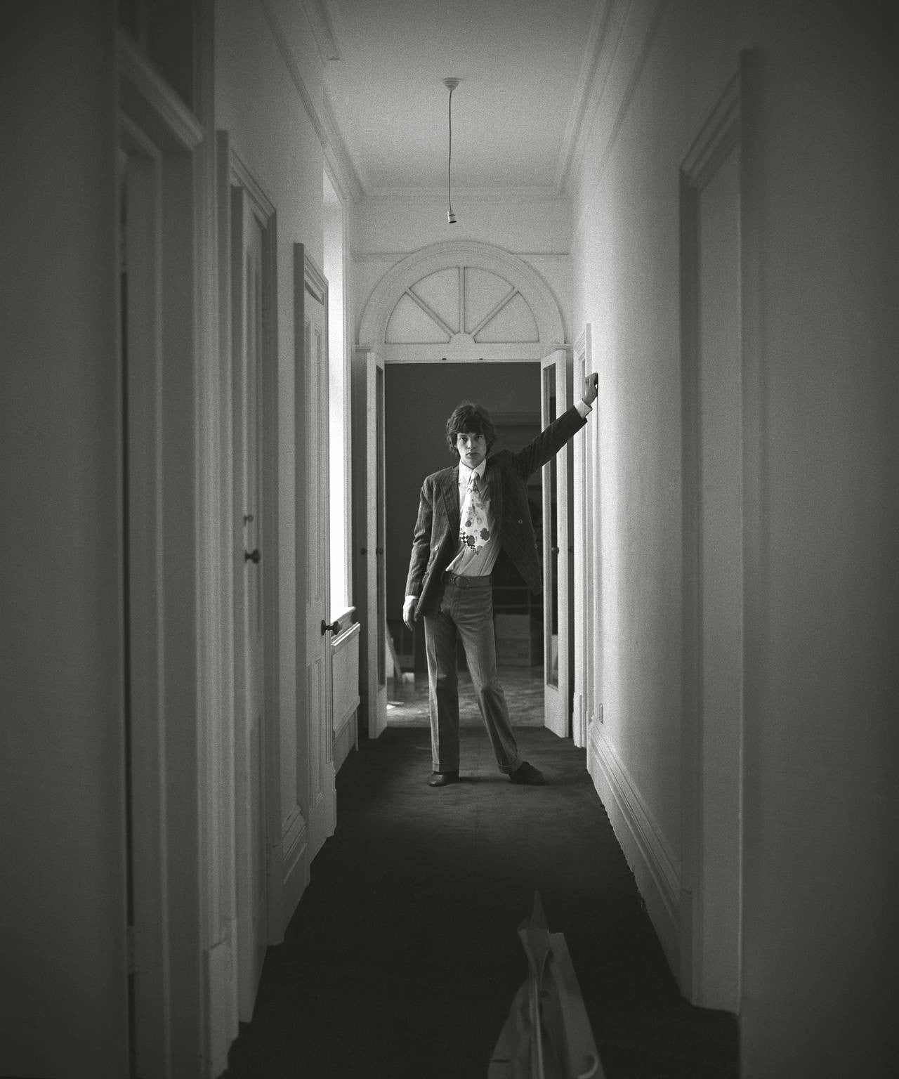 Mick Jagger in hallway of house. Chelsea, London. UK. 1966
