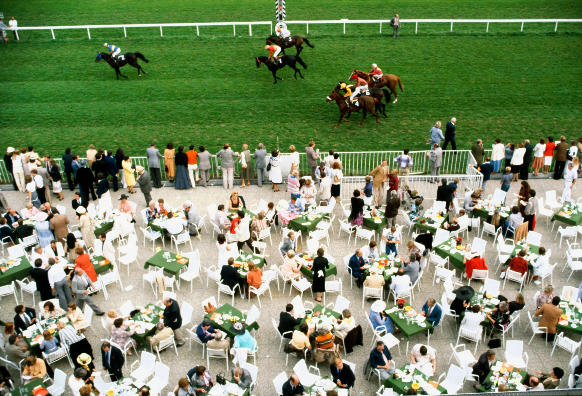 Spectators dine in the open air as the horses go by at Baden-Baden racecourse, Germany, September 1978.