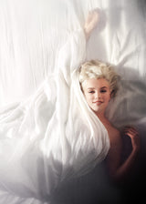American actress, model and singer Marilyn Monroe poses naked in bed for photographer Douglas Kirkland on the evening of November 17th 1961 in Los Angeles.