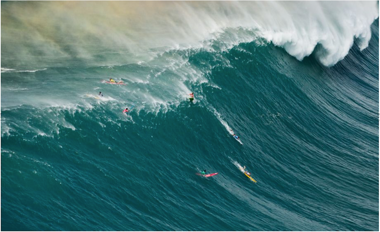 Mason Ho and John John Florence taking a wave at the Eddie Aikau Invitational 2014.