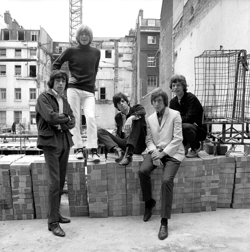 The Rolling Stones standing outside the photographers studio in Mason's Yard, London. UK 1965