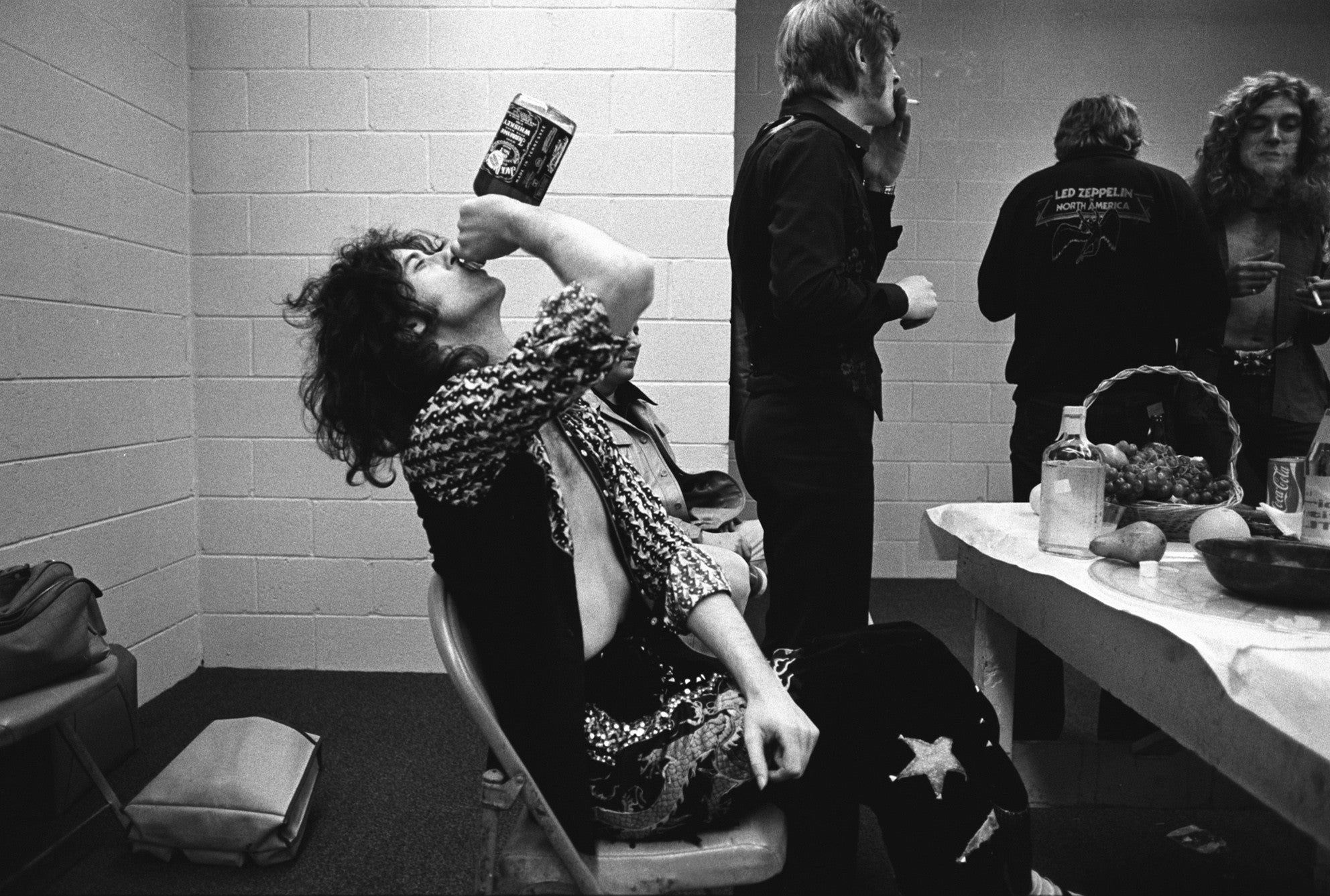 Jimmy Page backstage drinking Jack Daniels. Indianapolis, IN. 1975