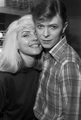 This photo was taken in 1977 and shows Debbie with a young David Bowie backstage during Iggy Pop's Idiot Tour, in which Bowie played the keyboard.