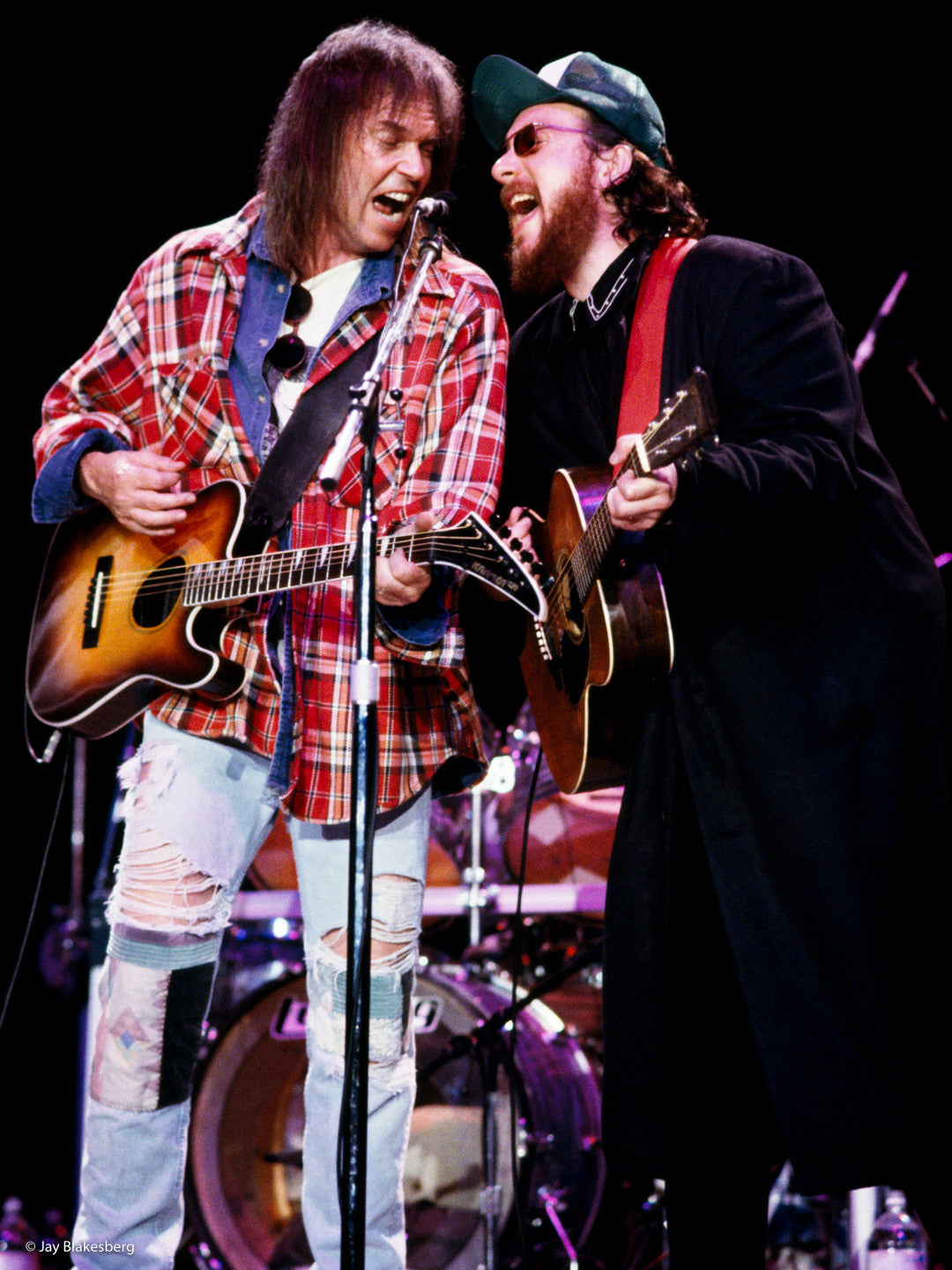 Neil Young and Elvis Costello performing.