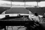Jackson Browne playing to a near-empty house during soundcheck at Pine Knob, near Detroit, MI during his "Running On Empty" US tour. August 1977