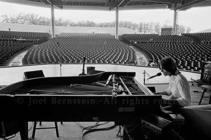 Jackson Browne playing to a near-empty house during soundcheck at Pine Knob, near Detroit, MI during his "Running On Empty" US tour. August 1977