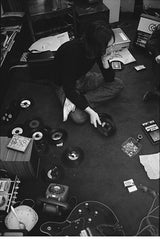 John Lennon, listening to test pressing 45s of The White Album in 1968.