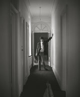 Mick Jagger in hallway of house. Chelsea, London. UK. 1966