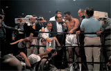 May 25th, 1965 - Muhammad Ali with media while trainer Angelo Dundee watches the instant replay of knockout, after winning fight vs. Sonny Liston at St. Dominick Arena in Lewiston, Maine.