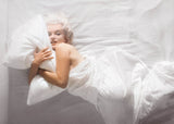 American actress, model and singer Marilyn Monroe poses naked in bed for photographer Douglas Kirkland on the evening of November 17th 1961 in Los Angeles.