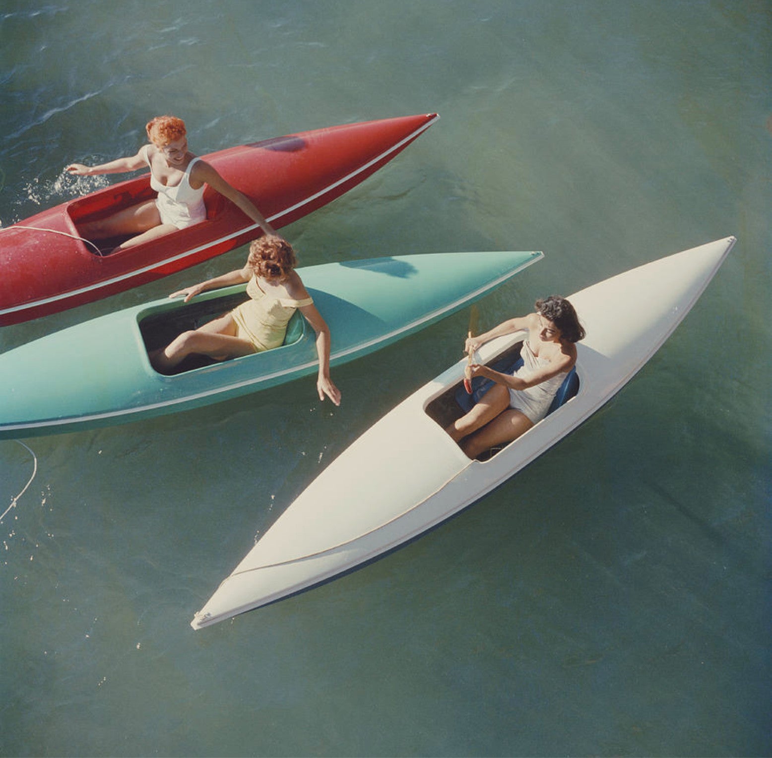 Young women canoeing at Zephyr Cove on the Nevada side of Lake Tahoe, USA, 1959.